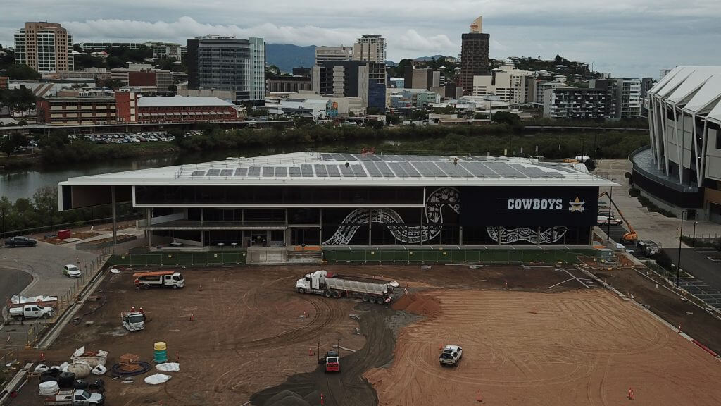North Queensland Cowboys Hutchinson Builders Centre under construction aerial view with trucks and city in the background