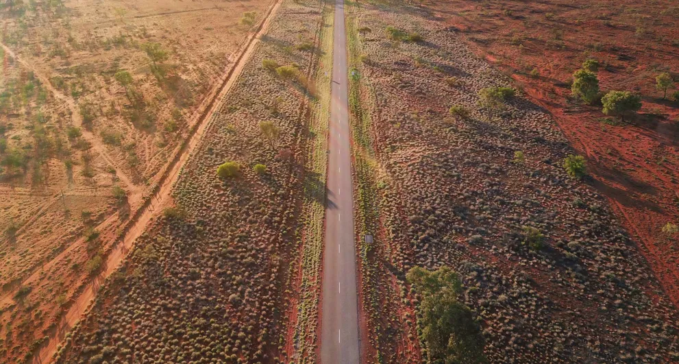 Aerial view of a long road in central Australia