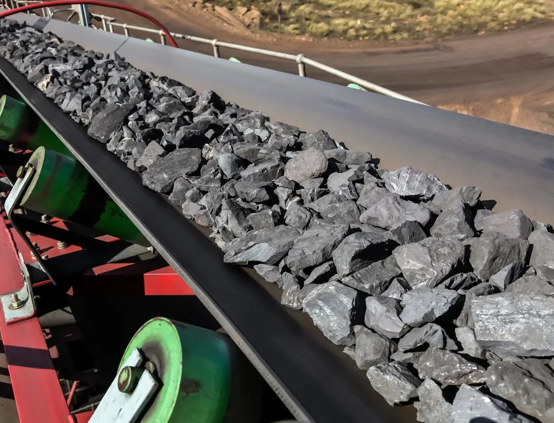 Manganese rocks travelling down a conveyor belt